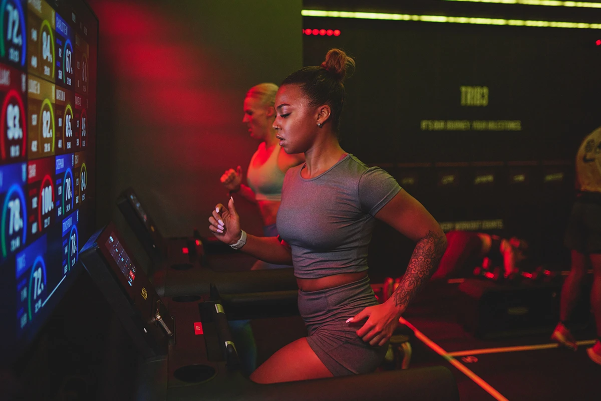 Women running on treadmills at TRIB3 studio, doing a HIIT workout