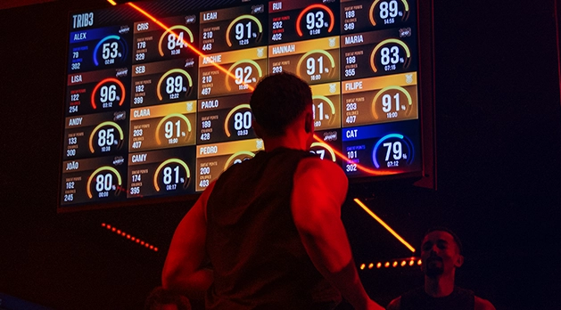 Man on the treadmill in the TRIB3 studio looking at the heart rate zone stats on the screen in front of him